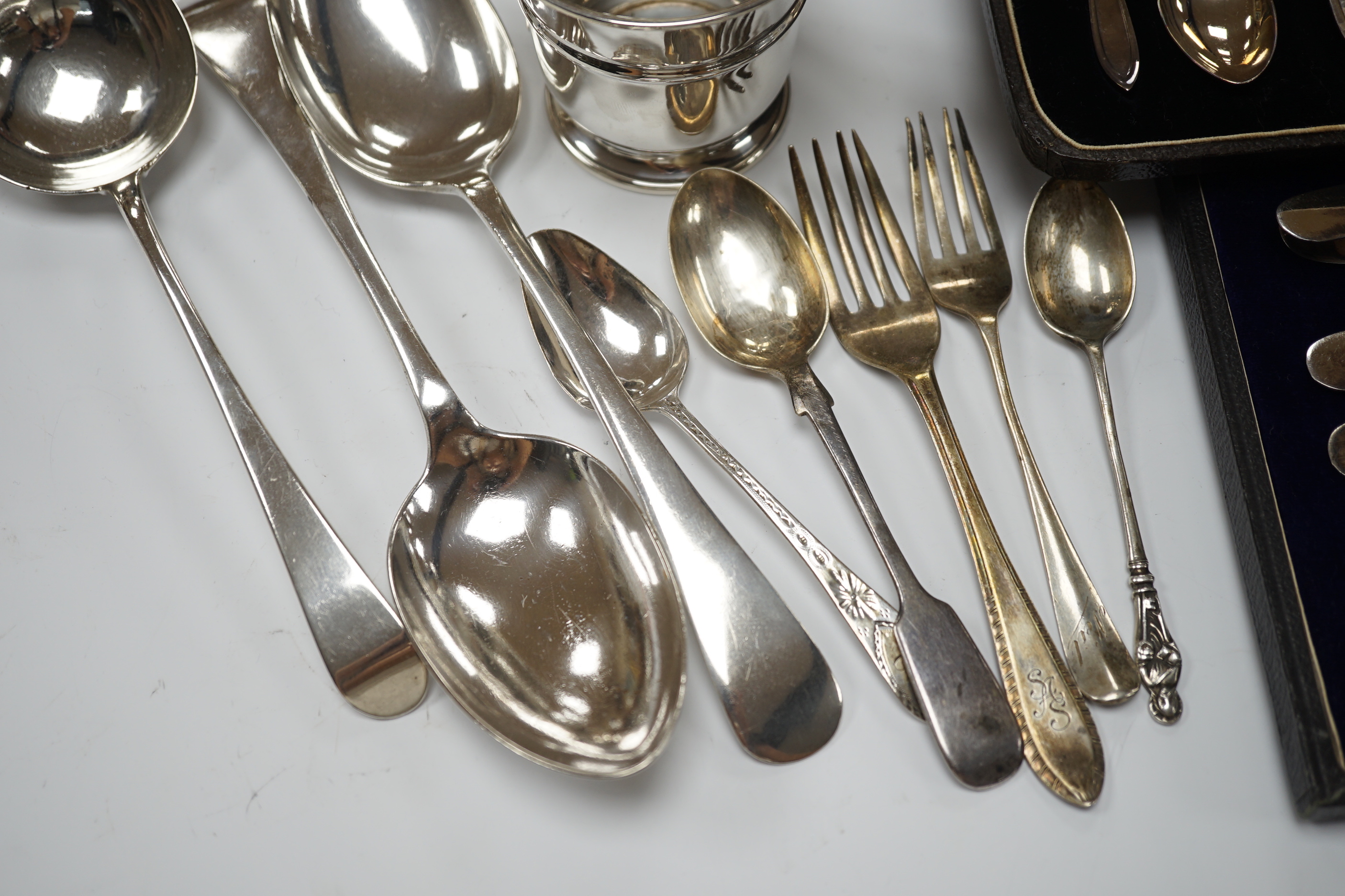 Two cased sets of silver flatware including teaspoons with tongs, nine assorted items of silver flatware including an 18th century base mark sauce ladle and a pair of later tablespoons and a small silver christening mug.